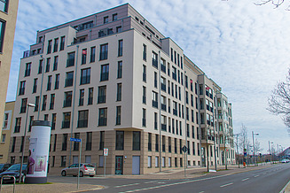 The picture shows the new construction of a residential complex with a beige façade.