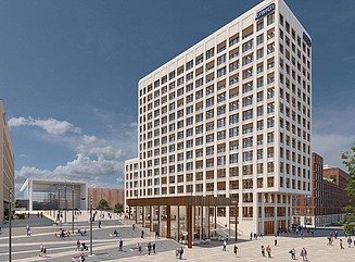 Helles Bürohochhaus mit vielen quadratischen Fenstern, Schriftzug KPMG oben rechts