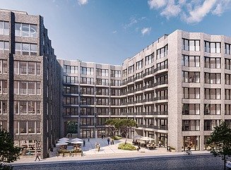 Hier sehen Sie ein Foto eines Bürogebäudes, eine ansprechende Rotklinker-Fassade und blauen Himmel