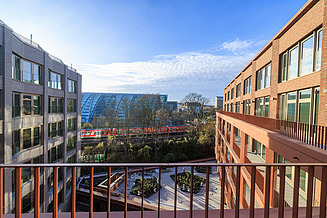 Here you can see a photo of an office building, an attractive red brick façade and blue sky