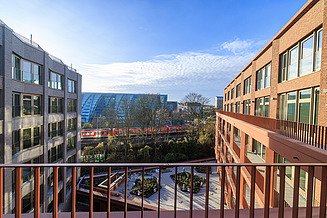 Here you can see a photo of an office building, an attractive red brick façade and blue sky